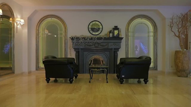 Luxurious study with fireplace. Panning shot of a sitting room in an expensive home with fireplace.