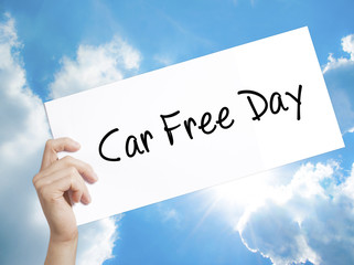 Car Free Day Sign on white paper. Man Hand Holding Paper with text. Isolated on sky background