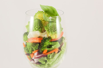 Mix cabbage romanesko, cauliflower and broccoli, sweet carrots and peppers on lettuce, capped with basil