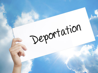 Deportation  Sign on white paper. Man Hand Holding Paper with text. Isolated on sky background