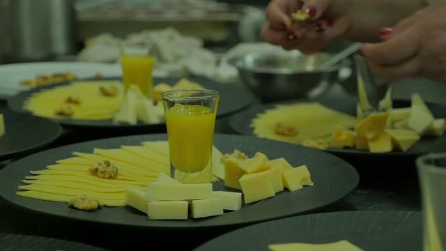 Chef finalizing a cheese in a kitchen. Close up hands no faces Chef prepare dinner using organic produce. Slow motion