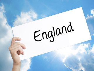 England Sign on white paper. Man Hand Holding Paper with text. Isolated on sky background