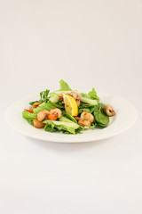 Sea salad with scallops, prawns, squid, cuttlefish, in duet with lettuce and cucumber, seasoned with olive oil and Provence herbs