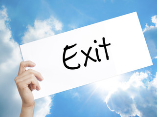 Exit Sign on white paper. Man Hand Holding Paper with text. Isolated on sky background