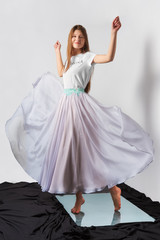 Fashion model in transparent skirt and shirt. Flying dress.