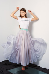 Fashion model in transparent skirt and shirt. Flying dress.