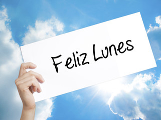 Feliz Lunes (Happy Monday In Spanish) Sign on white paper. Man Hand Holding Paper with text....