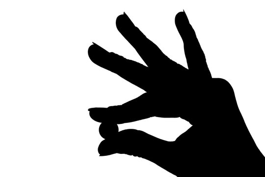 silhouette of hand with tablet in hand