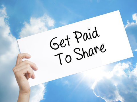 Get Paid To Share Sign on white paper. Man Hand Holding Paper with text. Isolated on sky background