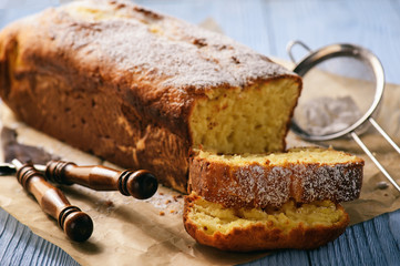 Sliced vanilla pound cake on wooden background. Selective focus.