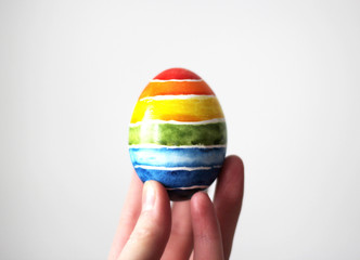 Fototapeta na wymiar Easter egg in hand on white background.
