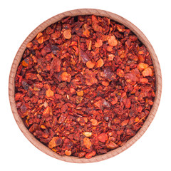 Dry paprika in a wooden bowl. Isolated on white background.