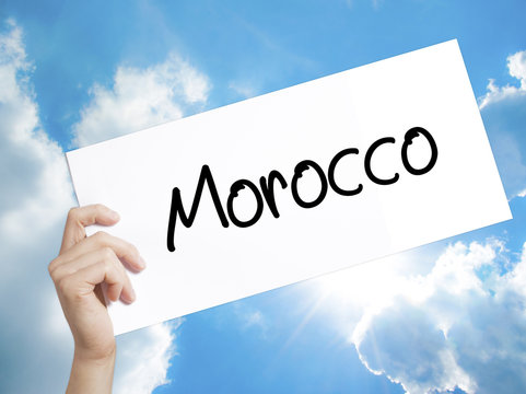 Morocco  Sign on white paper. Man Hand Holding Paper with text. Isolated on sky background