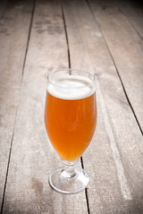 glass beer on wood background