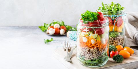 Homemade salad in glass jar with quinoa and vegetables. Healthy food, diet, detox, clean eating and vegetarian concept with copy space.