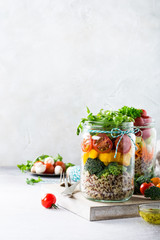 Homemade salad in glass jar with quinoa and vegetables. Healthy food, diet, detox, clean eating and vegetarian concept with copy space.