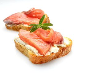 Salmon fillet sandwich with cream cheese isolated on white background.