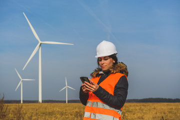 Young female specialist with smartphone