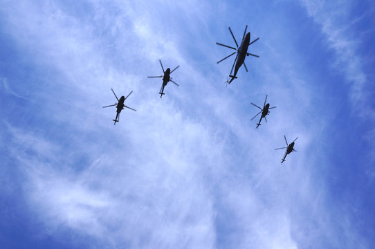 5 helicopters in the sky