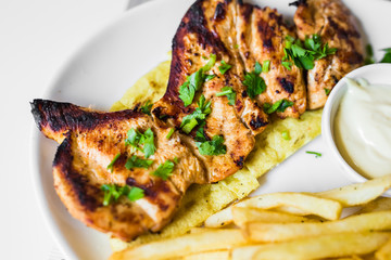grilled meat with french fries close up