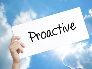 Proactive Sign on white paper. Man Hand Holding Paper with text. Isolated on sky background.