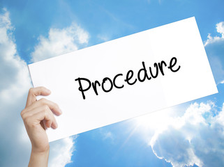 Procedure Sign on white paper. Man Hand Holding Paper with text. Isolated on sky background