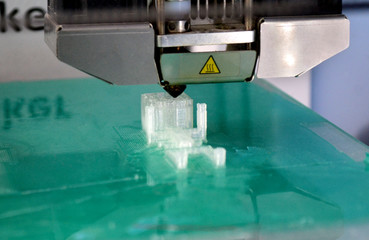 3D printer working and creating an object from the hot molten plastic close-up. Automatic three...