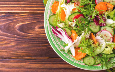 Fresh salad with salad mix, cucumber, radish and carrot
