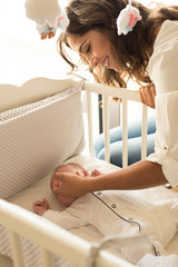 Obraz na płótnie Canvas Mother putting baby to sleep
