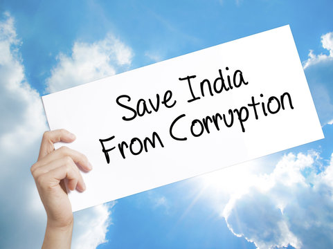 Save India From Corruption Sign On White Paper. Man Hand Holding Paper With Text. Isolated On Sky Background