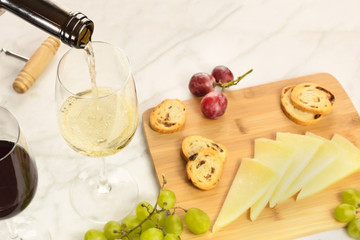 Wine, cheese, bread and grapes at tasting