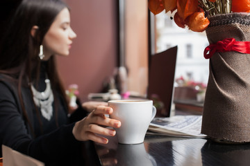 Beautiful brunette using laptop in cafe. coffee,