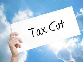 Tax Cut Sign on white paper. Man Hand Holding Paper with text. Isolated on sky background