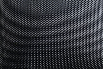 Black color of synthetic cloth texture close up photo show the detail of microfiber fabric texture surface background. 