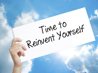Time to Reinvent Yourself Sign on white paper. Man Hand Holding Paper with text. Isolated on sky...
