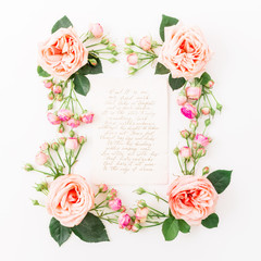 Floral frame of pink roses and paper card with calligraphy quote on white background. Flat lay, top view. Love background.