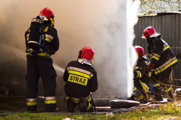 Obraz premium Fire garages, action fire extinguishing by the service: fire brigade and Police