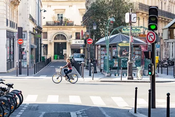 Gordijnen Woman riding a Velib bicycle in Paris © Guillaume Louyot