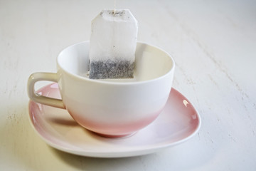 Tea bag put in white ceramic teacup
