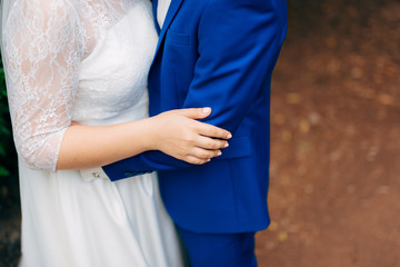 Bride and groom holding hands. Wedding in Montenegro.