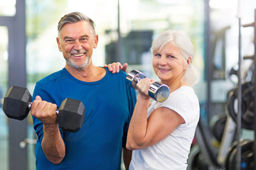 Senior couple exercising in gym
