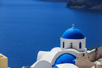 Santorini island in Greece - White church on blue background