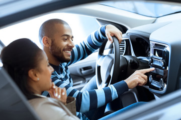 Happy couple sitting in a car