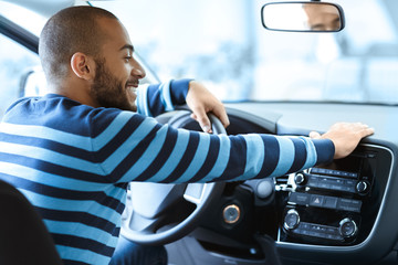 Happy male customer in a newly bought car