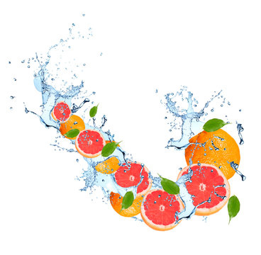 Water splash with grapefruits isolated on white background. Splash motion with fruits. Abstract object 