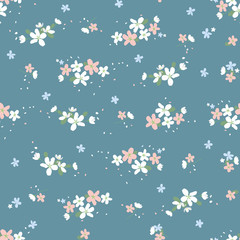 Seamless pattern with small flowers on a beige background. Spring light airy texture. vector.