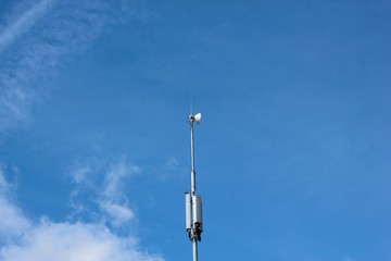 A cell phone tower on blue sky background