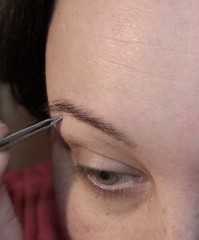 Woman removes facial hair