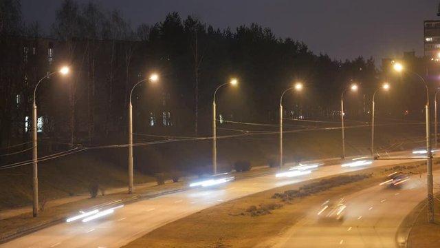 Traffic in the city. Long Exposure Time Lapse of Night Traffic in Vilnius, Lithuania. High-angle view from a bridge.