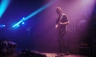 Fototapeta na wymiar Guitarist performing on stage.